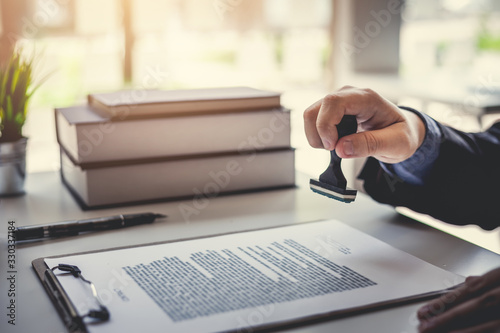 Fotografía Businessman stamping with approved stamp on document contract.