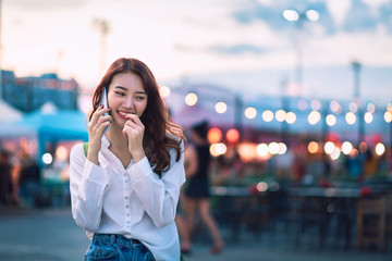 Sticker - Travel woman using mobile phone in street market