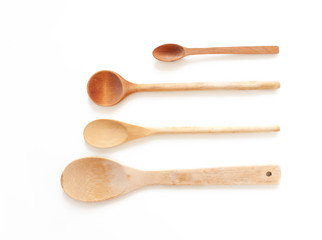 Set of wooden utensils for the kitchen on a white background. Isolated image