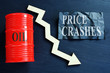 Price crashes sign and crude oil barrel with falling arrow.