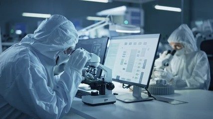 Wall Mural - Research Factory Cleanroom: Team of Engineers and Scientists in Coveralls Work on Computers, Use Microscope to Inspect Motherboard Microprocessor, Developing Electronics for Medical Electronics