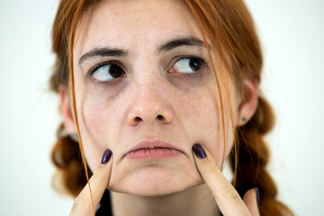 Wall Mural - Close up portrait of innocent looking redhead pretty teenage girl.