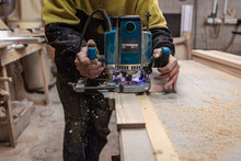 Milling A Wooden Part. A Joiner Processes A Wooden Product.