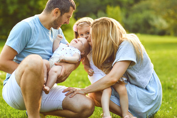 Wall Mural - Happy family have fun playing in the park.