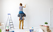 Anonymous  happy couple make renovating painting   wall at home.