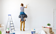 Anonymous  Happy Couple Make Renovating Painting   Wall At Home.