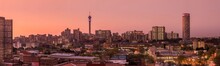 A Beautiful And Dramatic Panoramic Photograph Of The Johannesburg City Skyline, Taken On A Golden Evening After Sunset.