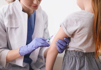 Wall Mural - Little girl receiving chickenpox vaccination in clinic, closeup. Varicella virus prevention