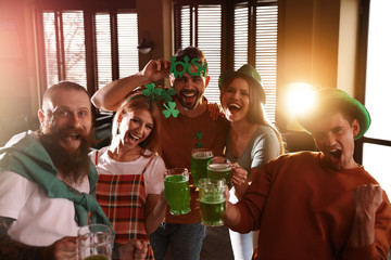 Sticker - Group of friends with glasses of green beer in pub. St. Patrick's Day celebration