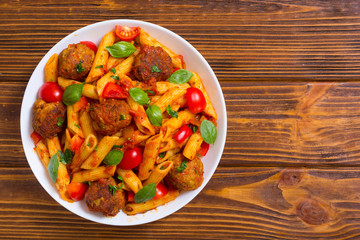 Canvas Print - Italian penne pasta with meatballs and tomatoes