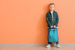 © Pixel-Shot - Cute little boy with backpack near color wall