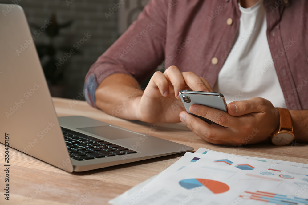 Handsome businessman working in office late at night