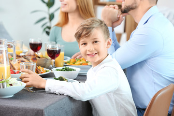 Wall Mural - Little boy with family celebrating Thanksgiving Day at home