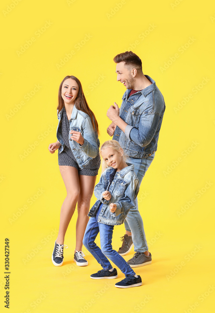Happy family dancing against color background