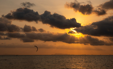 Wall Mural - Kitesurfing, action sport in twilight at sunset time