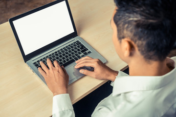 Wall Mural - Business person or office worker using laptop computer while sitting at desk.