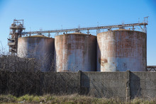 Old Abandoned Cement Silo With Blue Sky Background