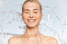 Photo Of  Young  Woman With Clean Skin And Splash Of Water. Portrait Of Smiling Woman With Drops Of Water Around Her Face. Spa Treatment. Girl Washing Her Body With Water. Water And Body.