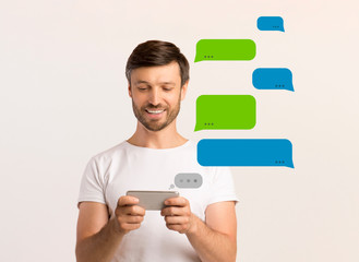 Poster - Live chat. Attractive young man communicating in social network on light background, blank space