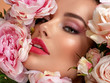 © Valua Vitaly - Beautiful white girl with flowers. Stunning brunette girl with big bouquet flowers of roses. Closeup face of young beautiful woman with a healthy clean skin. Pretty woman with bright makeup