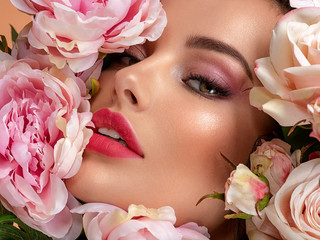 Wall Mural - beautiful white girl with flowers. stunning brunette girl with big bouquet flowers of roses. closeup