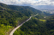 Aerial view of Malaysia's North South highway cutting through mountain jungle.