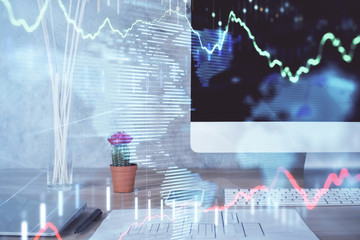 Forex graph hologram on table with computer background. Multi exposure. Concept of financial markets.