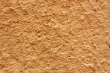 Fototapeta Las - Orange colour textured wall 