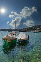 Poster - Two small boats moored in shallow water of a harbor