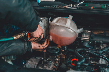 the master repairs the engine in the car service during a malfunction