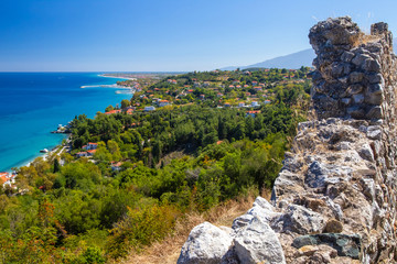 Canvas Print - Greece.The Peninsula Of Kassandra. Chalkidiki. Nea Phocea.The Village Of St. Paul.View of houses on the coast in Greece. A fragment of an ancient wall, a village on the coast and the Mediterranean sea