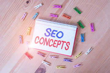 Poster - Handwriting text writing Seo Concepts. Conceptual photo a process of increasing the quality of website traffic Colored clothespin papers empty reminder wooden floor background office