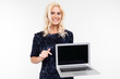 © Ivan Traimak - fashionable girl in a dress shows a blank template of a laptop on a white background