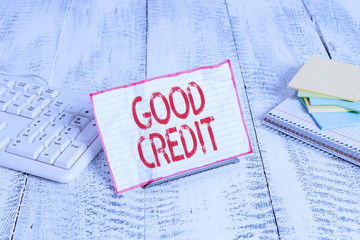 Handwriting text writing Good Credit. Conceptual photo borrower has a relatively high credit score and safe credit risk Notepaper stand on buffer wire in between computer keyboard and math sheets