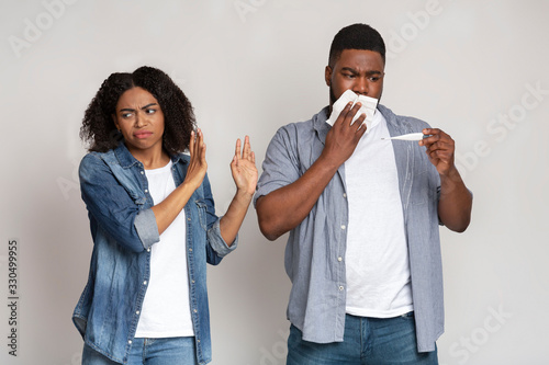 Risk Of Coronavirus Contamination. Woman avoiding contact with her sick boyfriend