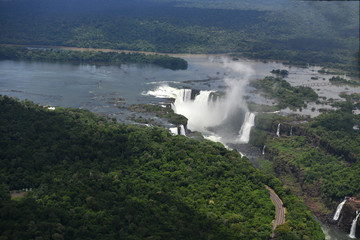 roaring waterfalls in the wild jungle from a helicopter