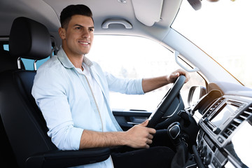 Wall Mural - Handsome man driving his new modern car