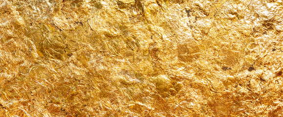 Texture of shiny gold leaf beautiful. Gold that has been smashed into thin sheets is used to close the gold to worship the Buddha.