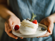 Woman With Mini Pavlova Cake In Plate