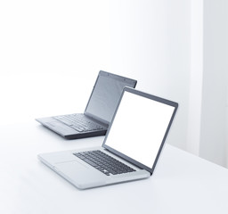 Laptop computer on desk with isolated screen for mockup.