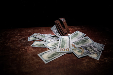 Stylish men's purse with money on wood background.