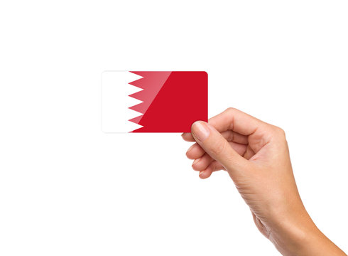 Beautiful hand holding Bahrain flag card on white background