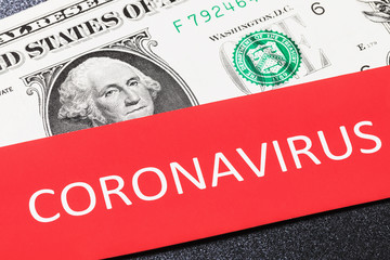 American currency and the sheet with the inscription, closeup. The concept of the effect of coronavirus on the dollar