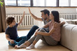 Leinwandbild Motiv Happy young family with little child sit on warm wooden floor relaxing together in own apartment, overjoyed parents rest enjoy weekend have fun with small son excited to move to new home