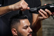 © AJ_stock_photos - the guy is a dark-haired Asian Indian appearance on a haircut in a barbershop . cinematic image