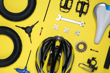 Sticker - Set of different bicycle tools and parts on yellow background, flat lay