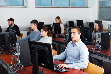 Wall Mural - Portrait of students at computers in university