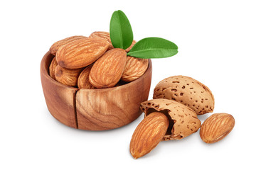 Almonds nuts with leaves in wooden bowl isolated on white background with clipping path and full depth of field.