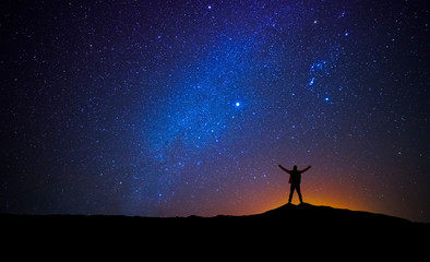 Wall Mural - man in front of the universe with his arms raised