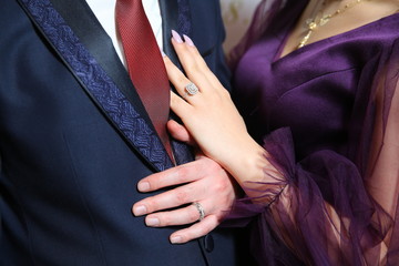 The bride's hand was placed on his chest . he placed his hand on the man's chest.